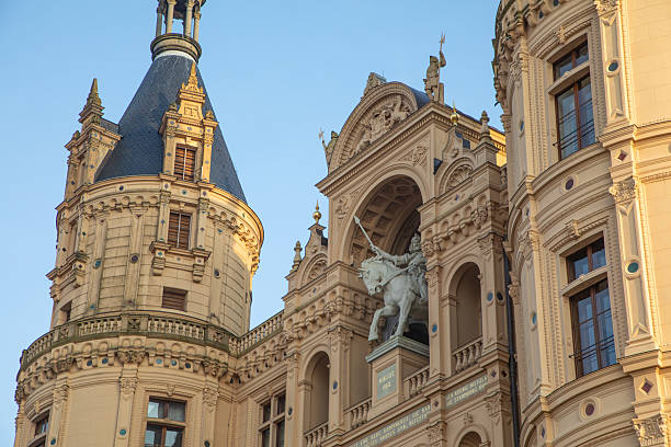 Ornate Stone Carving of Crowned Figure with Floral Relief on Historic Building
