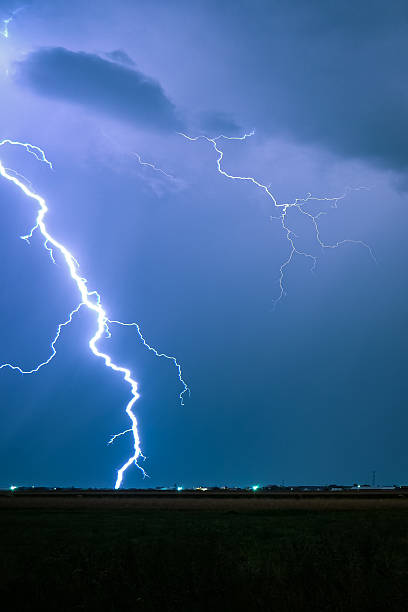 istock Close lightning bolt strikes down in wide open plains. 2241654158