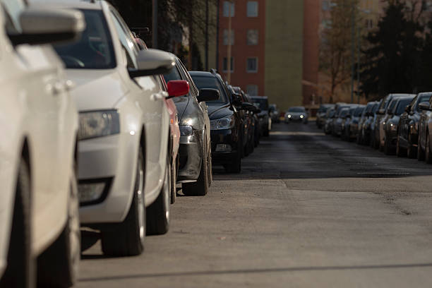 istock repetitive wheel arches and orderly suburban parking scene from low 2241654225