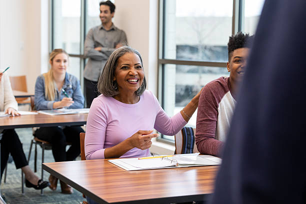 istock Diverse group of people engaged in learning and discussion in a classroom setting. 2241654453