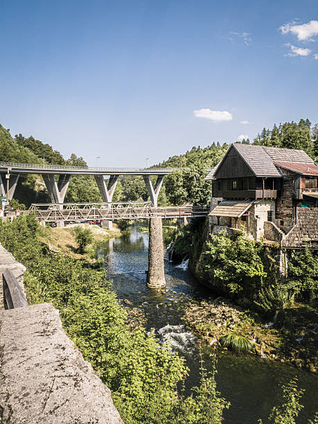 istock Old mill and modern bridge over river in Rastoke Croatia 2241658422