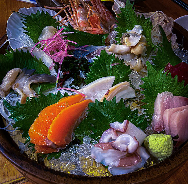 Selection of Japanese fish specialties artistically arranged on a plate, showcasing culinary craftsmanship, cultural heritage, and visual refinement