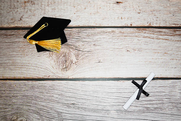 istock Graduation Cap and Diploma Flat Lay on Rustic Wooden Desk for Celebration, Education, Achievement, and Success 2241661815