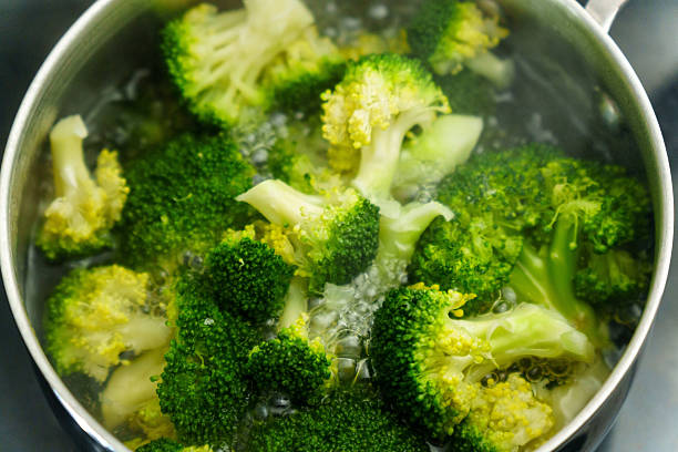 istock Cooking fresh broccoli in a saucepan over medium heat during a sunny afternoon 2241662975
