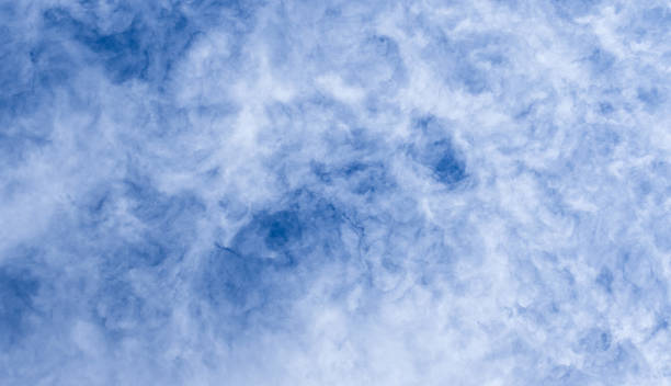 istock Blue sky filled with soft, wispy clouds creates a calm, expansive mood 2241663552