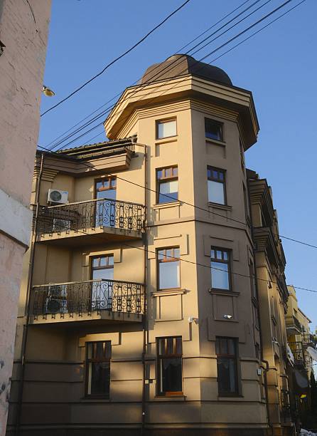 European architecture with balconies and an octagonal tower stands in morning sunlight