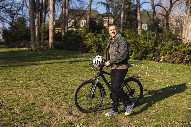 istock Man Walking With Bike In City Park 2241664090