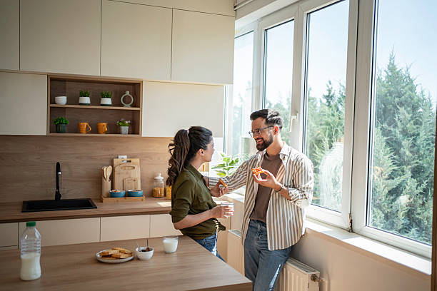 istock Couple enjoying morning breakfast, having casual conversation in kitchen 2241664419