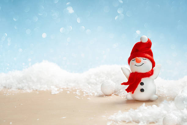 istock Snowman on snowy wooden surface, winter christmas background 2241666507