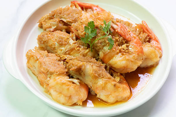 istock Deliciously cooked shrimp, garnished with herbs, presented in a white dish, ideal for seafood lovers and culinary enthusiasts. 2241669131
