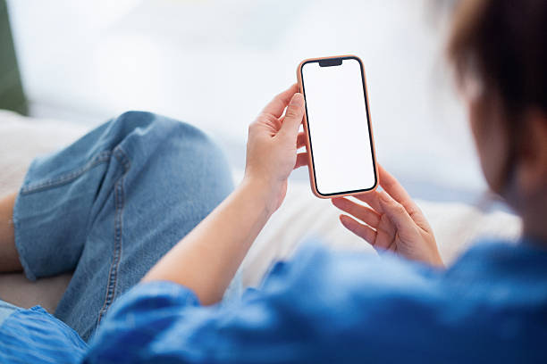 istock Relaxed Person Lounging On Sofa Viewing Smartphone With Blank Screen In Casual Home Setting 2241674320