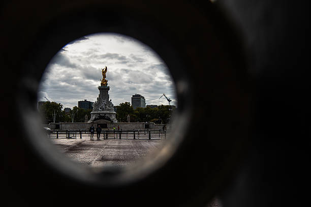 London, United Kingdom - October 16,  2022 - Color image showcasing a portion of the Victoria Memorial in London through the fences around Buckingham Palace, a monument dedicated to Queen Victoria, sculpted by Sir Thomas Brock and unveiled in 1911.