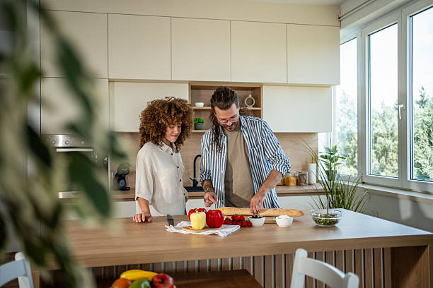 istock Couple preparing food and fresh vegetables in kitchen 2241688854
