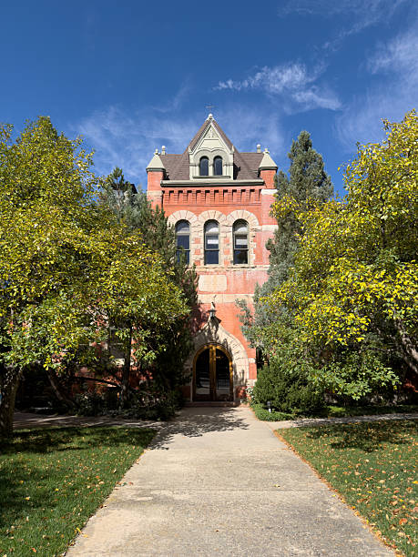 istock Historic brick building on school campus with path and trees 2241689390