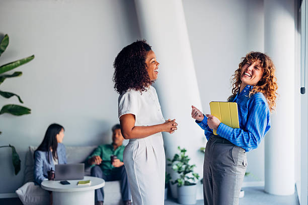 istock Colleagues Sharing a Laugh in a Bright and Modern Workspace 2241691498