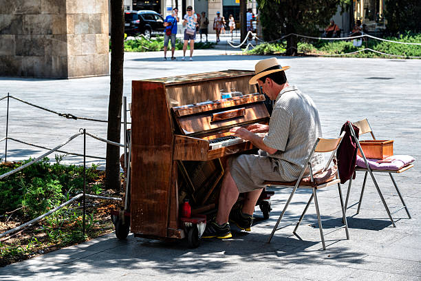 Santiago, Chile - May 15, 2017: A pianist playing the piano at the street in Lastarria neighborhood in autumn season.