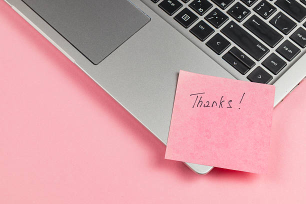 istock Note of gratitude placed on a laptop during work hours 2241697412