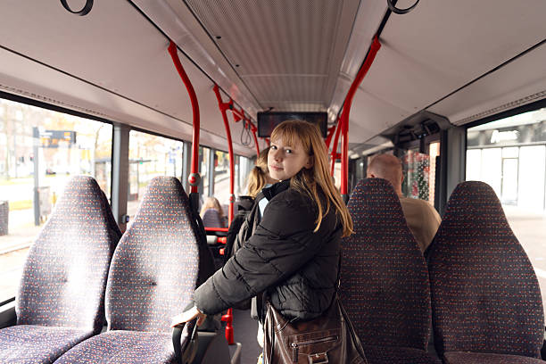 istock Two teenage sisters travelling to school together by bus 2241701607