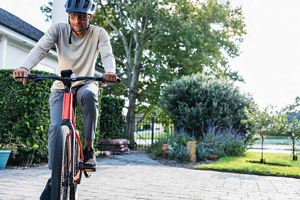 istock African-American man riding bicycle 2241704647