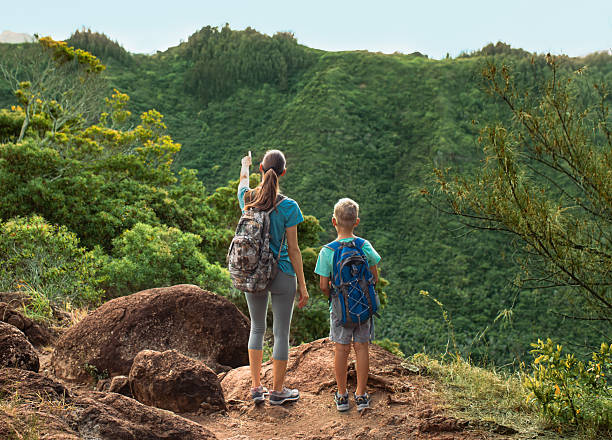 Mother and son hiking in a mountains in Hawaii.