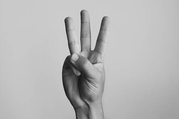 istock Hand sign gesture showing three fingers on white background. 2241704725