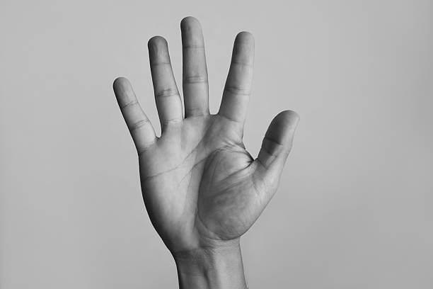 Hand showing five fingers on white background.