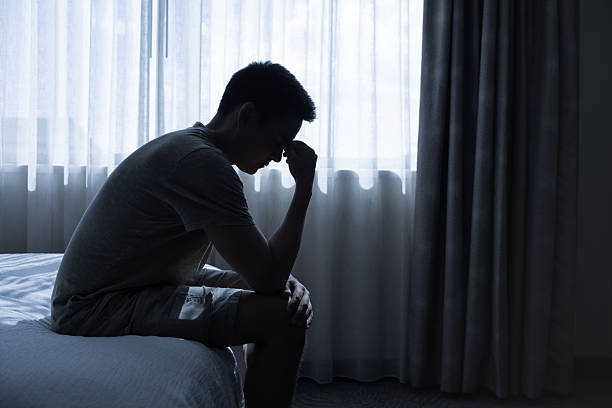 istock Man sitting on bed feeling frustrated and hopeless. 2241704750