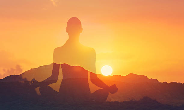 istock Woman meditating in beautiful nature setting at sunset. 2241705315