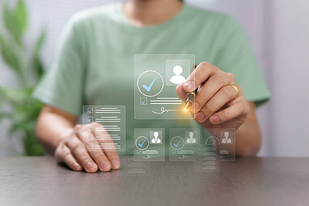 istock Electronic signature for identity verification, background check, and personal data verification. Online contract in the office. A woman uses a pen to sign on a hologram on a paperless virtual screen. 2241705381