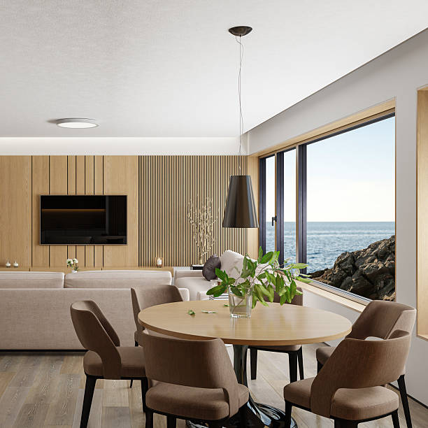A harmonious open-plan interior combining Japandi elegance with Scandinavian simplicity, featuring a light wood dining table and chairs set against a vertical pine slat wall that adds warmth and texture. The adjacent kitchen area showcases sleek cabinetry in white and dark wood finishes, with clean lines and minimalist detailing that enhance the calm, functional aesthetic. A pendant light above the table and subtle decor elements complete the balanced composition. This image is ideal for illustrating modern apartment living, editorial content on Japandi interiors, or visualizations focused on natural materials and serene spatial design.