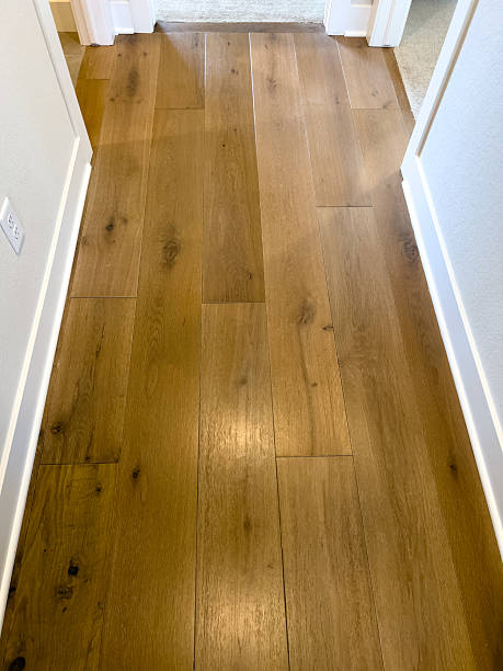 istock Narrow Hallway with Natural Wood Flooring 2241708056