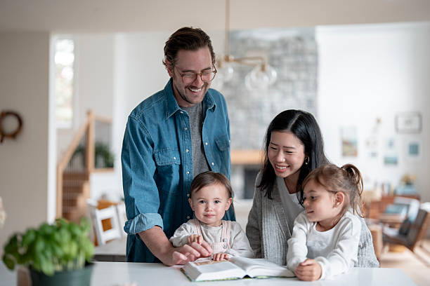 istock Happy Multiracial Family Reading a Cookbook Together in a Bright Kitchen 2241709087