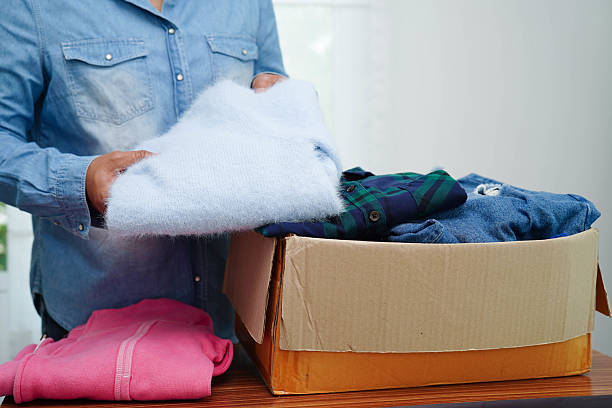 istock Clothes donations in cardboard box for volunteer. 2241711720