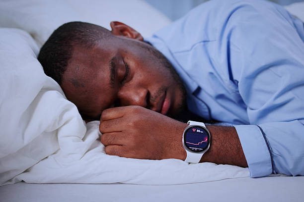 istock Man Wearing Black Smartwatch Tracks Sleep During Late Night Napping 2241714821