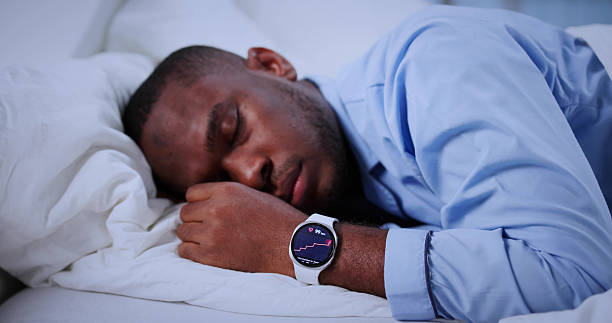 istock Man With Smartwatch Tracking His Sleep In Cozy Bed Late Night 2241714884