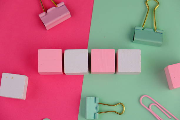 blank paper next to school tools with no word as a template for text space concept. business and education concept. pink background