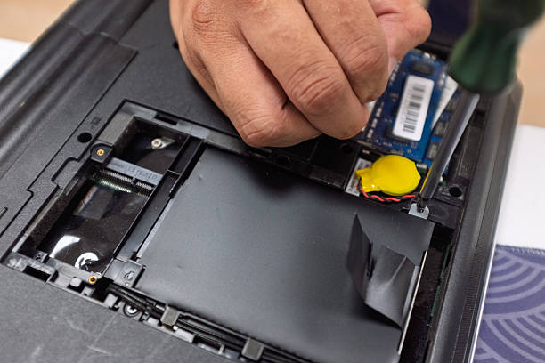 istock Hand holding screwdriver to repair laptop 2241723177