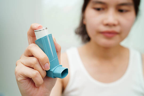 istock Asthma and chronic obstructive pulmonary disease COPD, Asian teenage using metered dose inhaler MDI. 2241735051