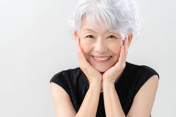 istock Senior woman doing skin care on white background 2241737565