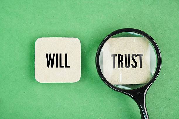 istock A magnifying glass with the words trust vs will. 2241737638
