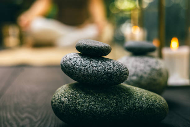 istock Stack of smooth zen stones with soft candle light and blurred meditative background 2241738354