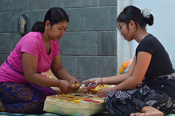 istock Balinese mother teaches daughter arranging ceremonial leaf patterns 2241742550