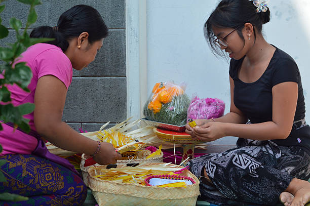 istock Balinese mother and daughter preparing palm leaf materials together 2241742559