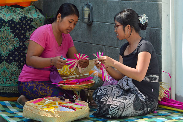 istock Mother and daughter comparing red and natural leaf weaving 2241742704