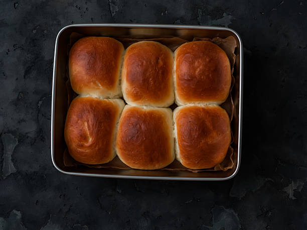 istock Homemade buns in a baking dish on a dark background, top view 2241742869