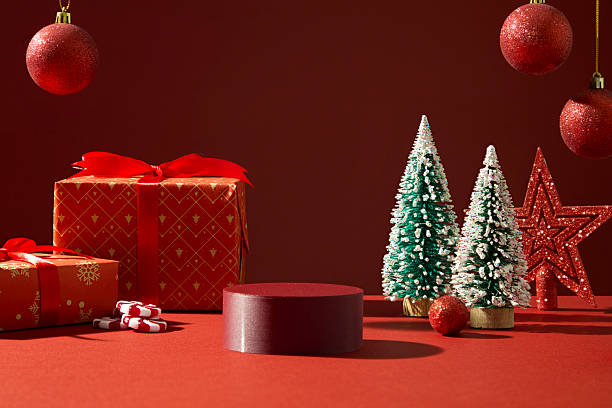 istock Red podiums, trees, and ornaments decorated on red background. Background for Christmas campaigns. Space for design 2241748412