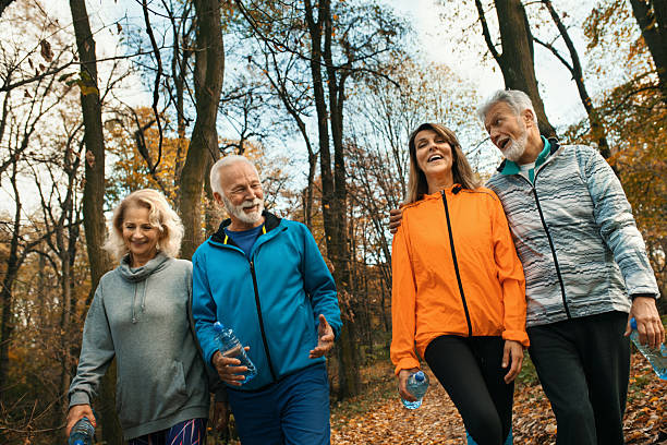 istock Group of mature hiking through a forest. 2241749912