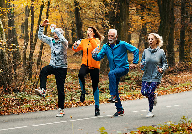 istock Group of mature folks jogging in a forest. 2241749928