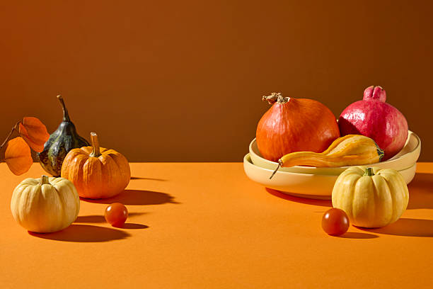istock Minimal pumpkin still life on a bright orange surface. Clean, modern autumn aesthetic for seasonal ads, product placement, and holiday creatives. 2241750738