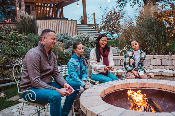 istock Family roasting marshmallows over open flame, campfire on backyard. 2241751228